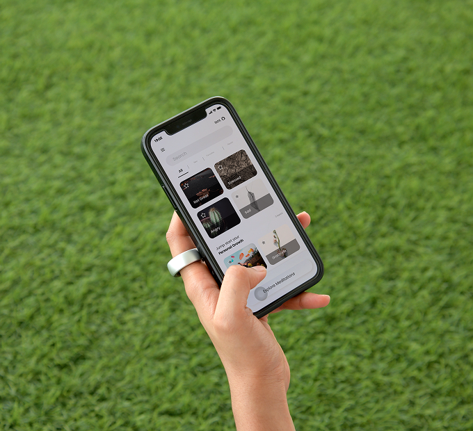 Dhyana 2 app shown on a phone held outdoors