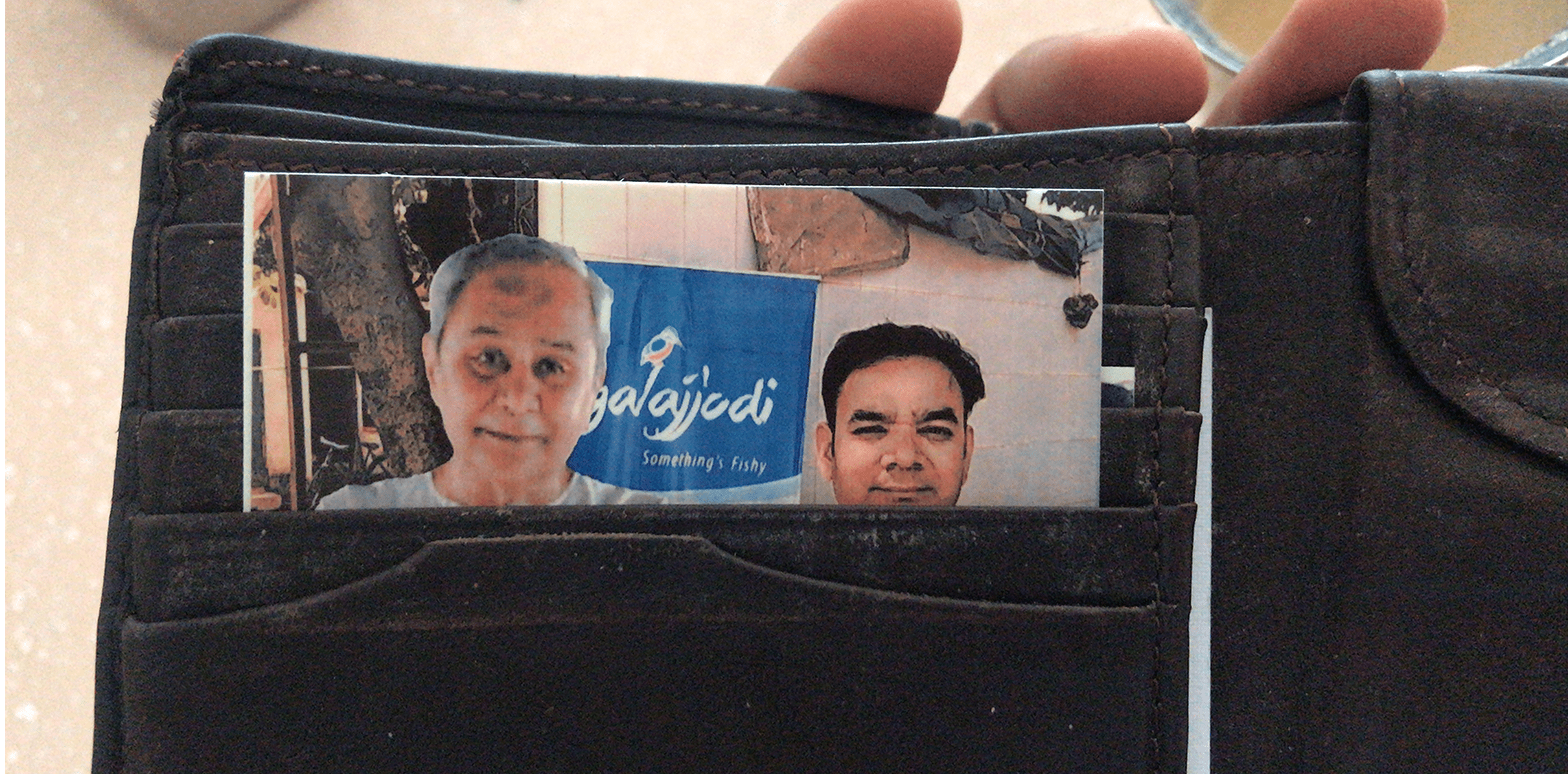 Printed photograph of the chief minister held in a wallet