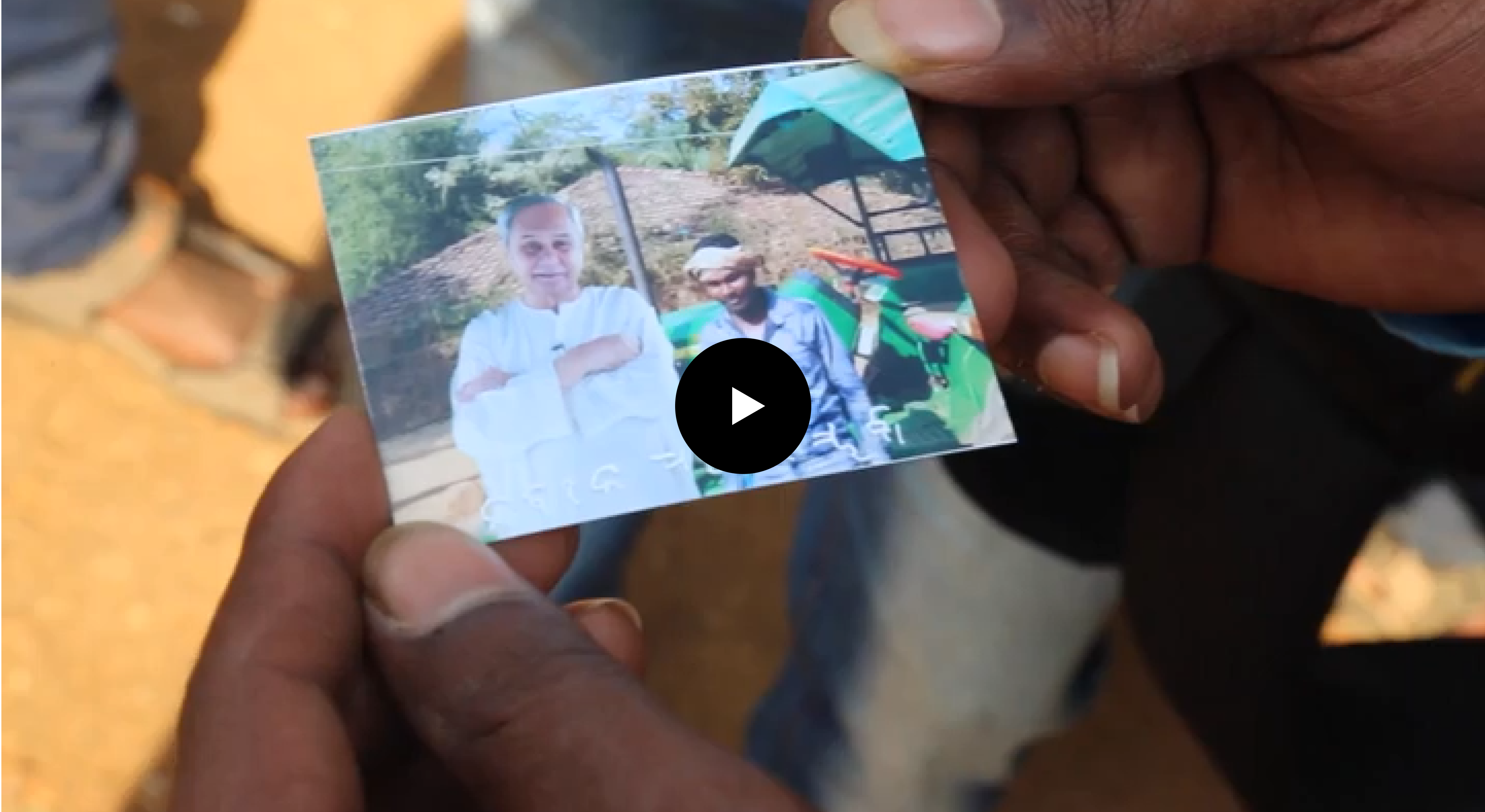 Villager holding a printed photograph